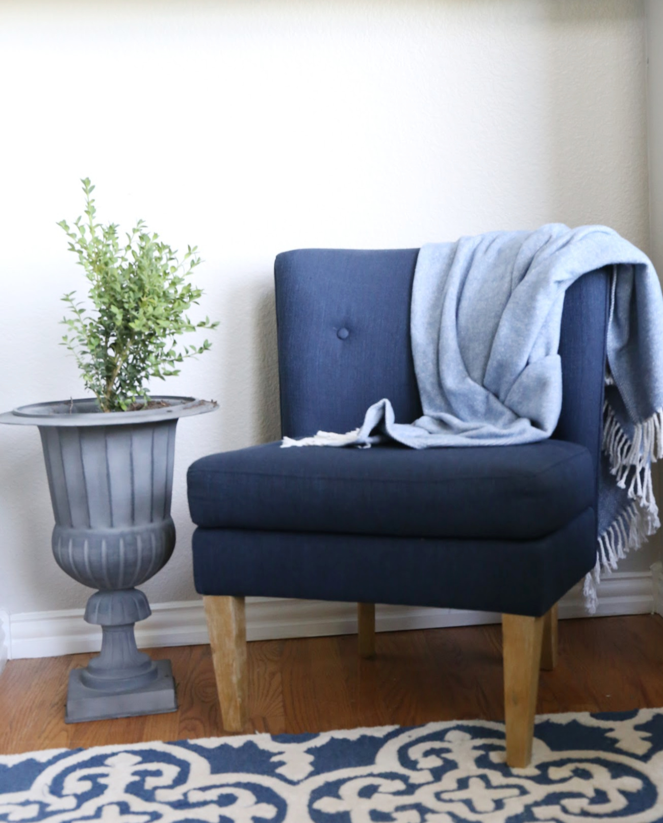 HOMEGOODS UPHOLSTERED CHAIR IN THE CORNER OF ALIVING ROOM